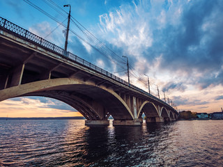 Fototapeta na wymiar Vogres Bridge panorama over Voronezh river at dramatic sunset background