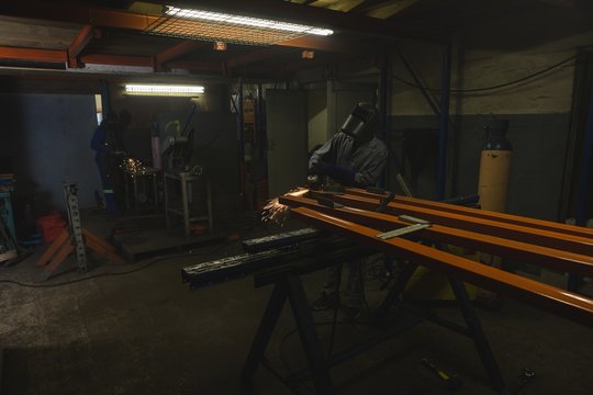 Worker using grinder in rope making industry 
