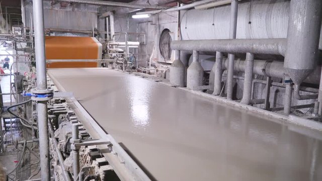 20709_The_gray_liquid_mixture_on_the_machinery_in_paper_mill_in_Rapina_Estonia.mov