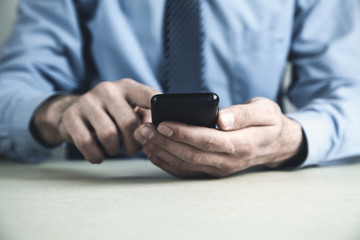 Man using smartphone in his desk. Business concept