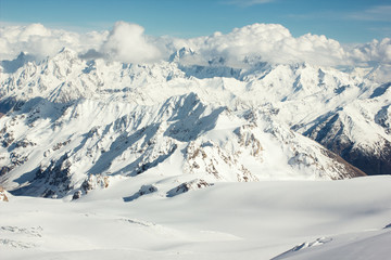 Fototapeta na wymiar Snowy mountain landscape with clouds.