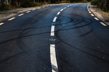 Car tyre skid marks on a rural road