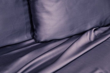 Beautiful bedding on the bed with expensive dark black silk
