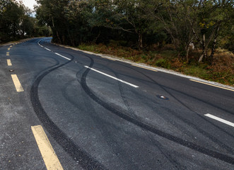 Car tyre skid marks on a rural road