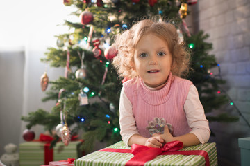  girl in a room with a Christmas tree