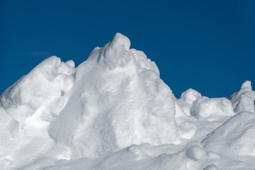 Large Snowpile Against Dark Blue Sky
