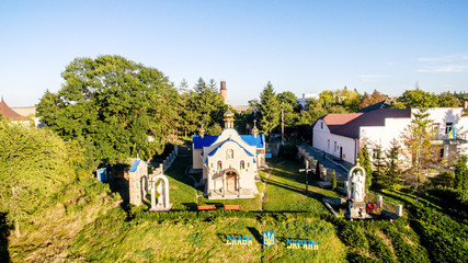 Fototapeta na wymiar Aerial view of the new church near the pine forest. Ukraine