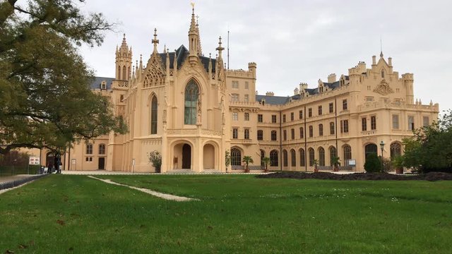 Lednice Castle, South Moravia, Czech Republic in autumn cloudy day. Czechia architectural tourist attraction. UNESCO world heritage. Chateau, park and garden at Lednice. Romantic neo-gothic palace