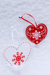 Christmas decoration in the shape of a heart in the snow.