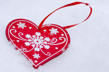 Christmas decoration in the shape of a heart in the snow.