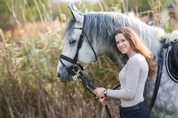 Young woman with a horse