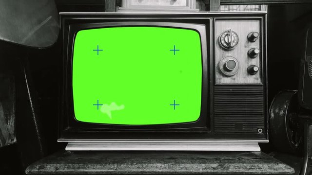 Vintage TV Black And White Television Zoom In. Old Television retro style green screen with old film effect. Zoom in