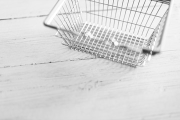 empty shopping basket on wooden table with copyspace