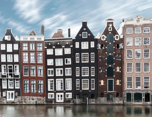 Obraz premium Long exposure picture of traditional Amsterdam old town architecture