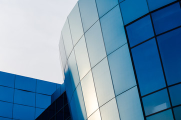 facade of an office building with blue walls and mirrored windows