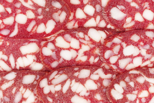 .Slices of salami. background. sausage cut.uncooked smoked.mincemeat..
