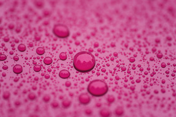 Closeup waterdrops on purple ceramic coated paint surface