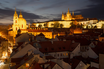 Fototapeta na wymiar Prague - The St. Nicholas church, Mala strana, Castle and Cathedral at dusk.