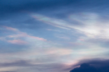 Cloud iridescence background and texture or irisation phenomenon effect, polar stratospheric clouds on blue sky.