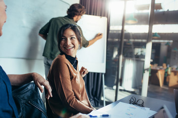 Woman smiling during business presentation in office