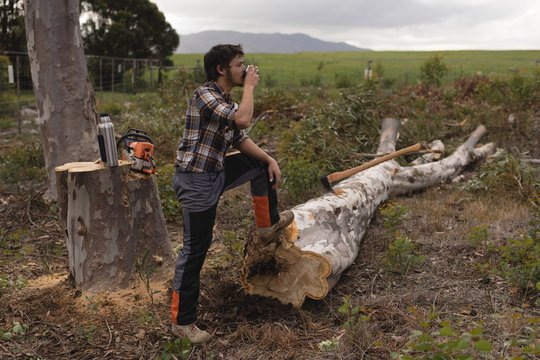 Lumberjack having a glass of water