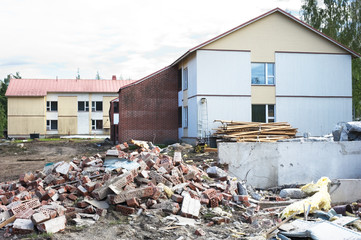 Pile of brick debris at a building demolition site. Construction waste recycling.