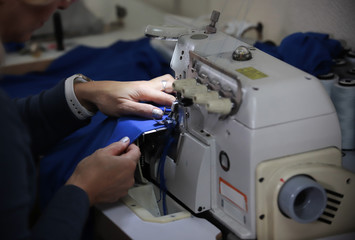 Working with a sewing machine. No face shown