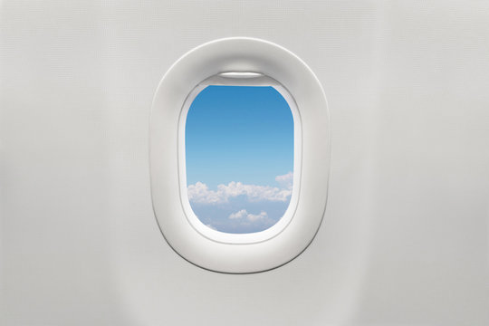 Isolated airplane window with blue sky