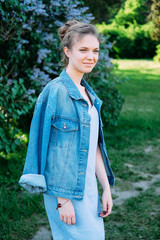 Cute stylish young woman in denim jacket