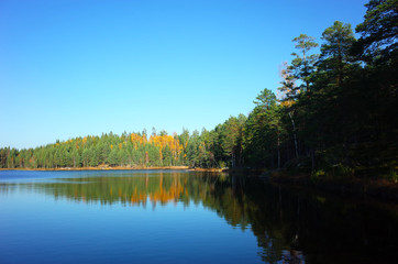 Nature of Sweden in autumn, Calm lake Stora Abbortjarnen with forest reflection, Peaceful outdoor image
