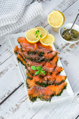 Gravadlax - Nordic dish of thinly sliced raw salmon cured in salt, sugar and dill and accompanied...