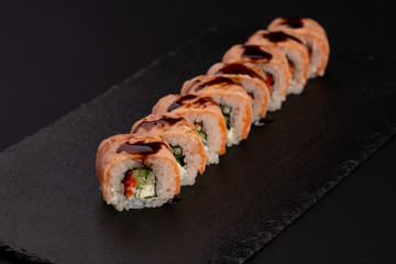 Japanese cold roll with salmon on black background