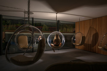 Woman sitting in a bubble chair