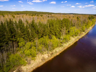 drone image. aerial view of rural area with fields and forests with river and water reflections
