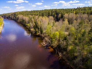 drone image. aerial view of rural area with fields and forests with river and water reflections