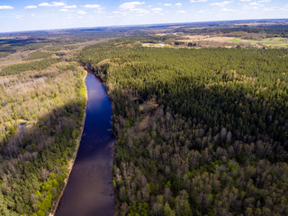 Fototapeta na wymiar drone image. aerial view of rural area with fields and forests with river and water reflections