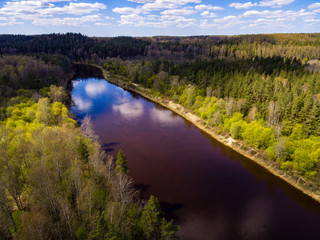 drone image. aerial view of rural area with fields and forests with river and water reflections