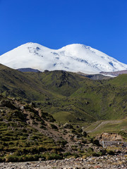 Panoramic view of the northern slope of Mount Elbrus of the Caucasus Mountains in Russia. Snow-covered peaks