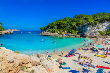 Cala Llombards beach in the summer holiday with people enjoying the vacation - Mallorca Balearic Islands in Spain - obrazy, fototapety, plakaty