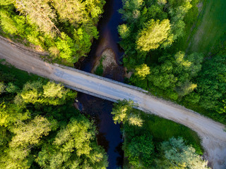 drone image. aerial view of rural area with fields and forests with river and water reflections