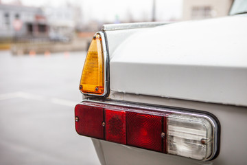 Left taillights of a retro car, after the rain