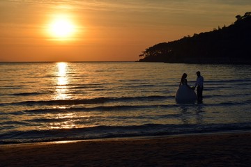 Naklejka na ściany i meble İn love. Sunset on sea. Seascape. Seashore. Dawn in the resort town of Akyaka. The port of Akyaka. Autumn.
