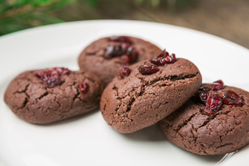 Homemade chocolate cookies on wooden table background.