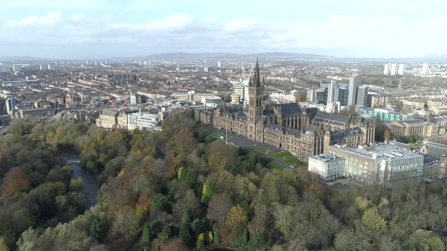 Aerial footage from over Kelvingrove Park in Glasgow. Flying right with view of Kelvingrove park, River Kelvin, Glasgow University Tower and the cityscape.