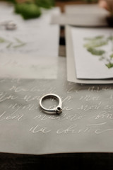 wedding ring lies on the wedding invitations and the letter to the bride hernich calligraphy letter design decorative