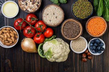 Healthy food,  berries, vegetables, seeds, superfood, cereals on wooden background top  view