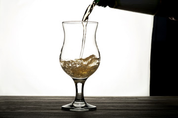 pouring a drink into a glass