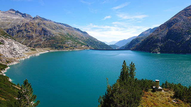 Arch dam (K&ouml;lnbreinsperre) in Austria (K&auml;rnten) at 1.890 meters height. Beautiful blue lake with blue skies. Perfect scenery for hiking in the mountains. The lake is called K&ouml;lnbreinspeicher.