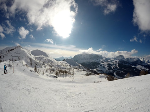 Panorama view from the mountains in Carinthia (K&auml;rnten), Austria. Blue sky, sun and perfect ski slopes high on top of the ski resort Nassfeld. Beautiful winter in the Alps.