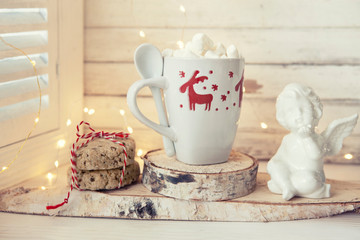 Homemade cookies and cup of cocoa with marshmallow in christmas decoration